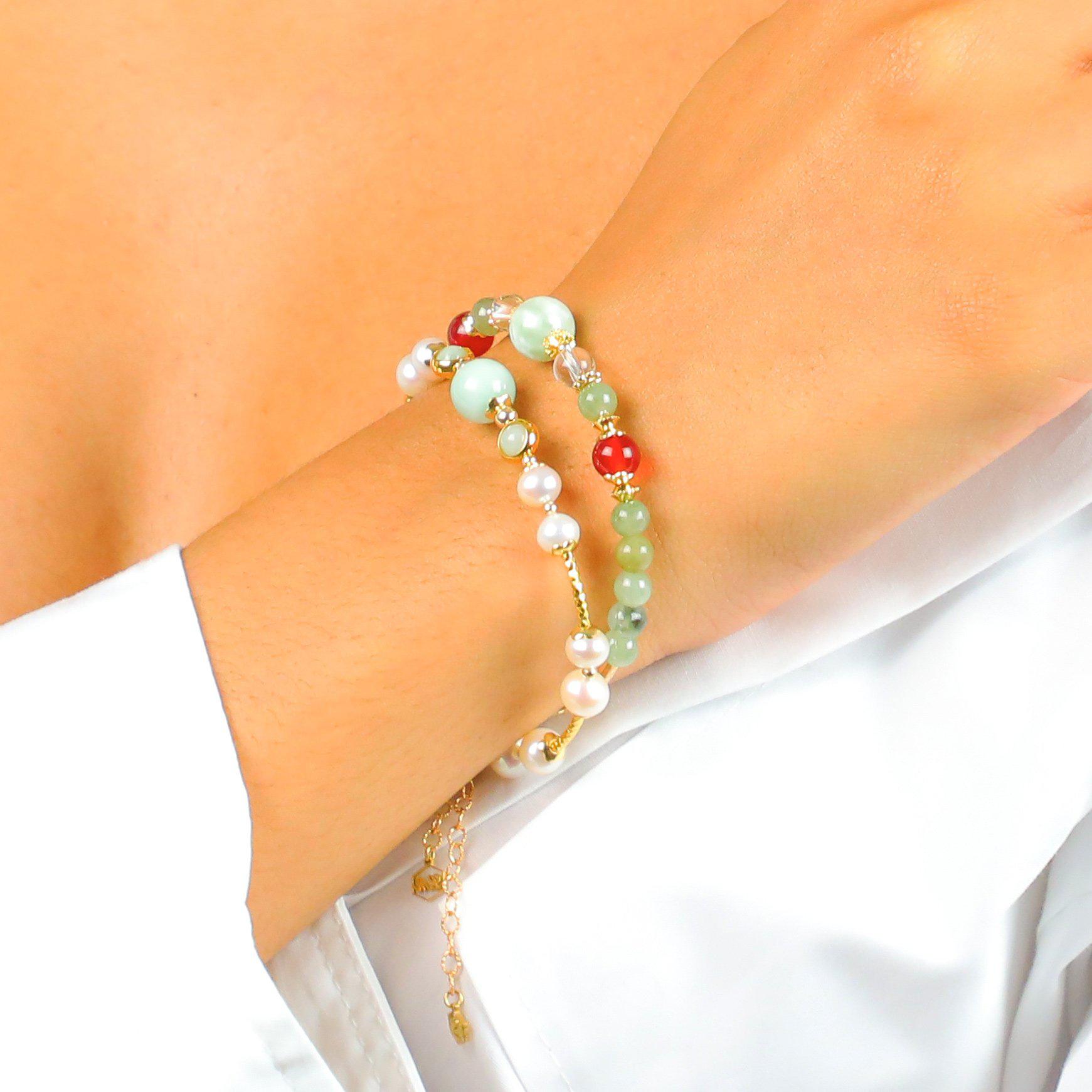 Model wearing two bracelets with Pearls and colorful stones